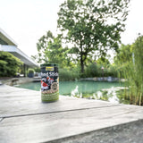 Tetra Pond Food Sticks canister near a pond, ideal for daily feeding of pond fish for healthy growth and vitality.