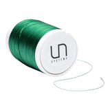 UN Systems green thread spool, perfect for creating vibrant eco-friendly projects or crafts.