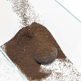 UNS Controbase nutrient-rich substrate for planted aquariums, showing granules and a mesh scoop.