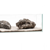 Aquarium setup showcasing natural rocks on a sandy substrate, ideal for aquascaping with UNS Controsand.