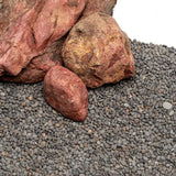 UNS Controsand Kona natural substrate with gray granules and decorative rocks for aquariums and terrariums.