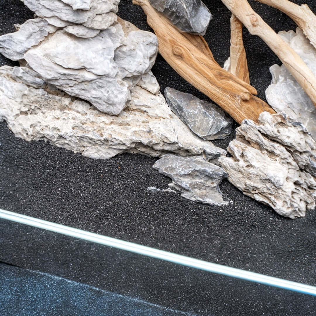 Natural substrate and wood decor setup in a freshwater aquarium with UNS Controsand Maui for aquascaping.