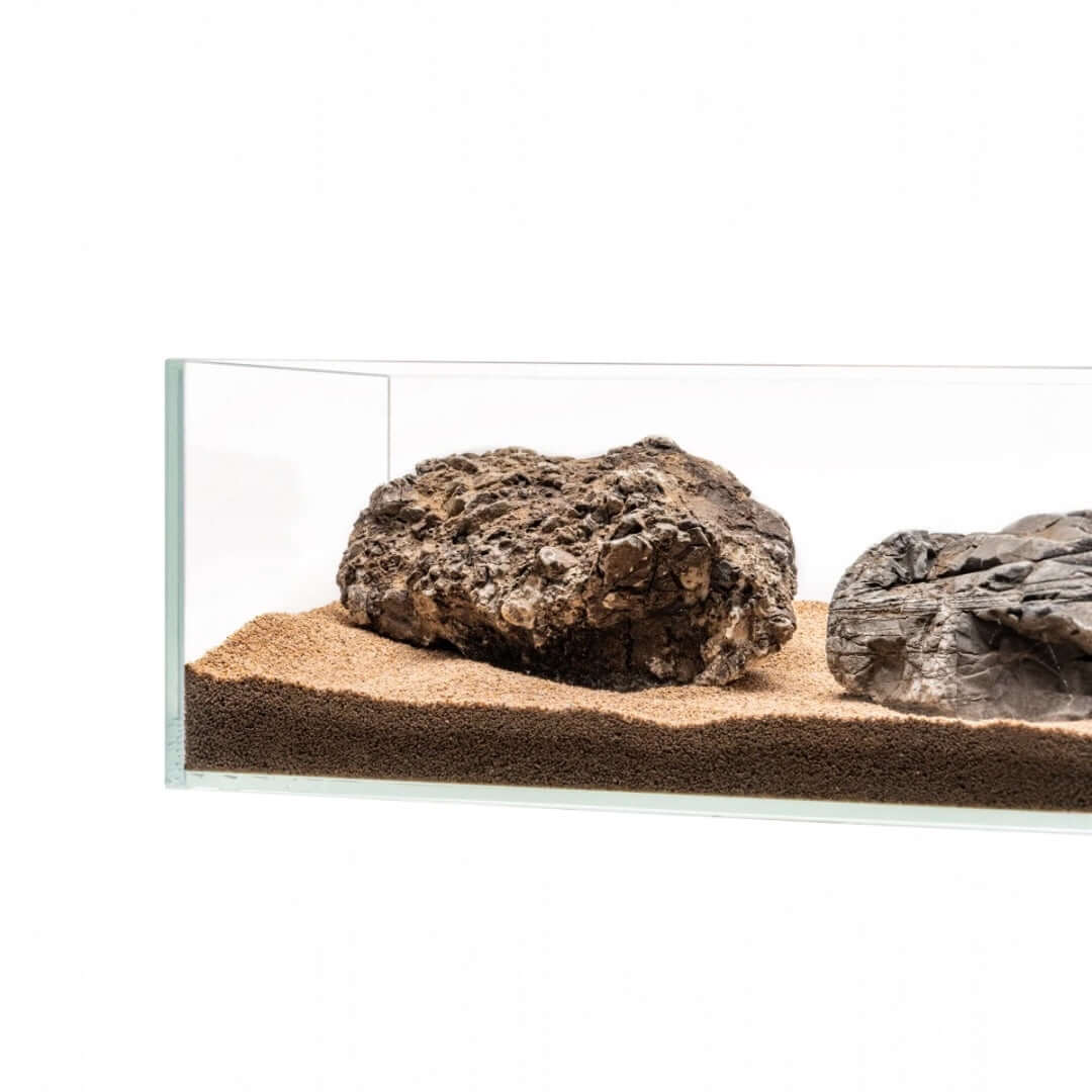 UNS Controsand Mojave natural substrate in an aquarium with decorative rocks for aquascaping.