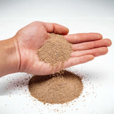 Hand holding UNS Controsand Mojave substrate, showcasing natural blend for aquariums and terrariums.