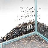 UNS Controsand Santa Fe substrate spilling into an aquarium, perfect for aquascaping freshwater environments.