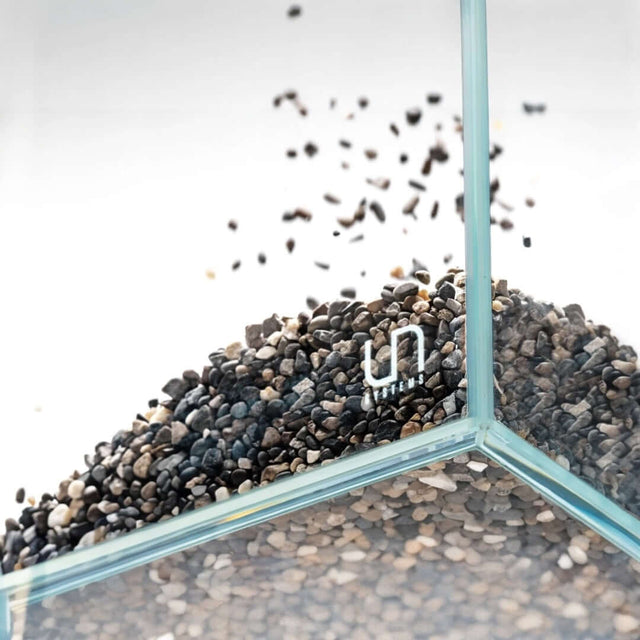 UNS Controsand Santa Fe substrate spilling into an aquarium, perfect for aquascaping freshwater environments.