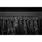 Close-up of smooth black surface with water droplets and vapor, showcasing condensation effects.