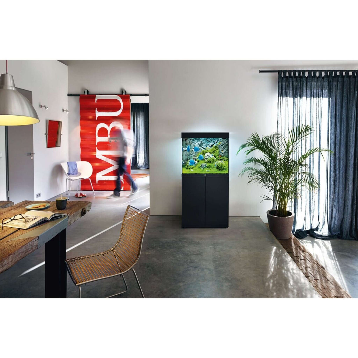 Juwel Lido Aquarium and Cabinet displayed in a modern living room with stylish decor and greenery.