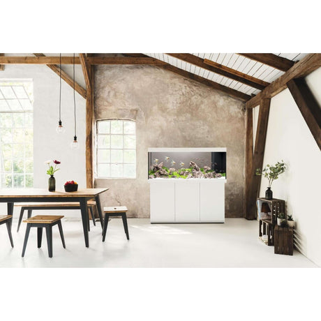 Juwel Rio Aquarium and Cabinet in a stylish interior with wooden beams and a modern dining table.