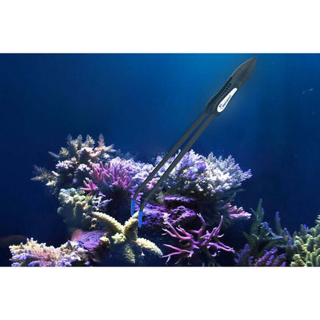 Maxspect Coral Tweezer hovering in colorful coral reef, showcasing neutral buoyancy and silicon-coated tips for delicate handling.