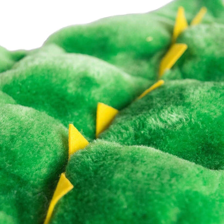 Close-up of Outward Hound Squeaker Matz Gator plush texture with green fabric and yellow accent details.