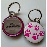 Pet ID Tag featuring pink paw prints and contact information for lost pets, ideal for ensuring pet safety.