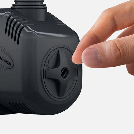 Close-up of a hand adjusting the knob on a Seachem Impulse pump, showcasing its user-friendly design.